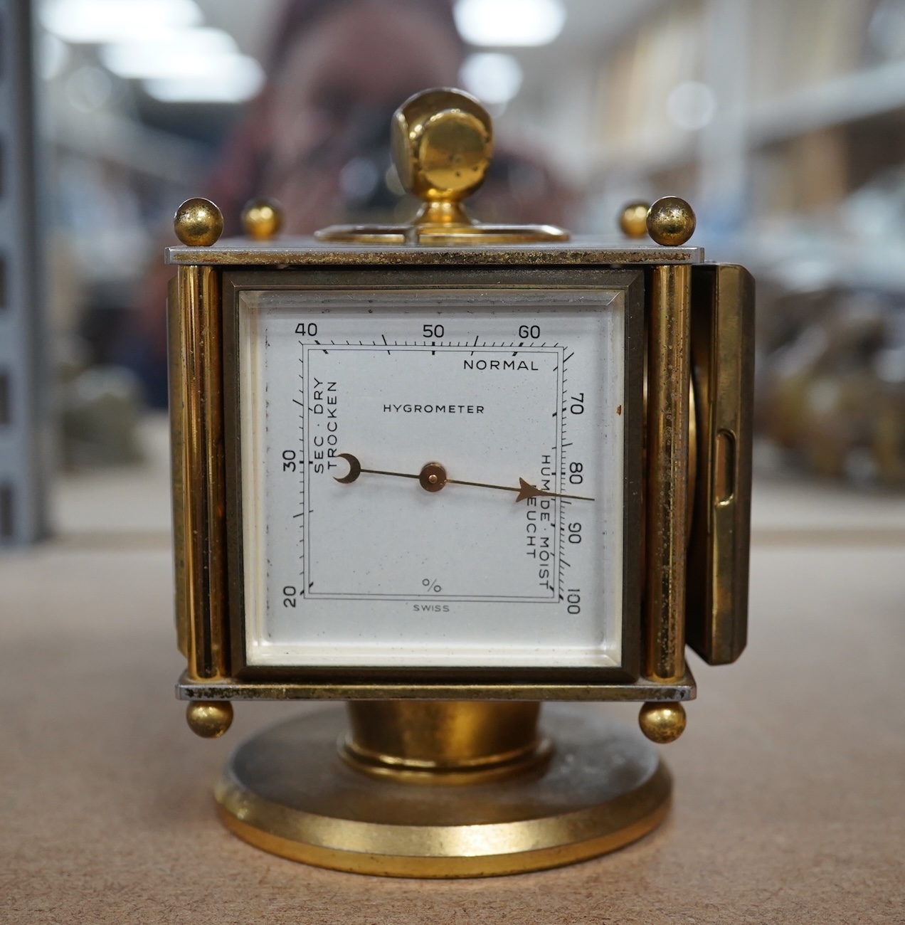 An Imhof brass combination clock, hydrometer, barometer and thermometer, 12cm high. Condition - fair